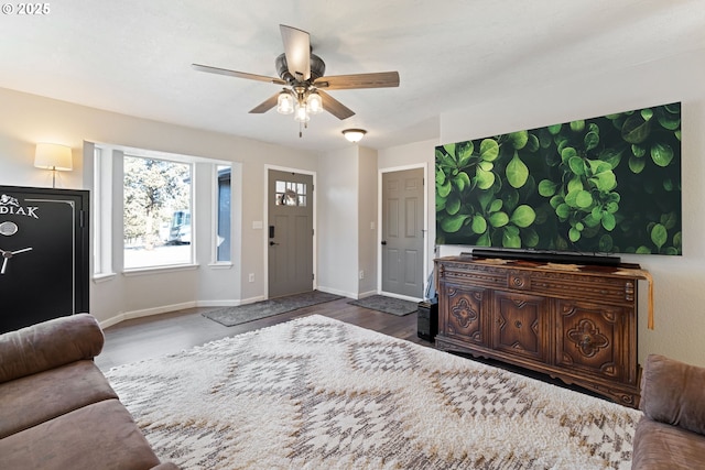 entryway with ceiling fan and baseboards