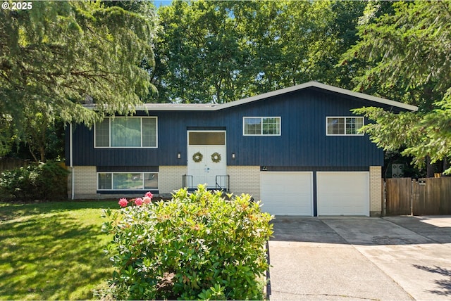 14370 SW Wilson Dr, Beaverton, OR 97008 - raised ranch with brick siding, an attached garage, and driveway