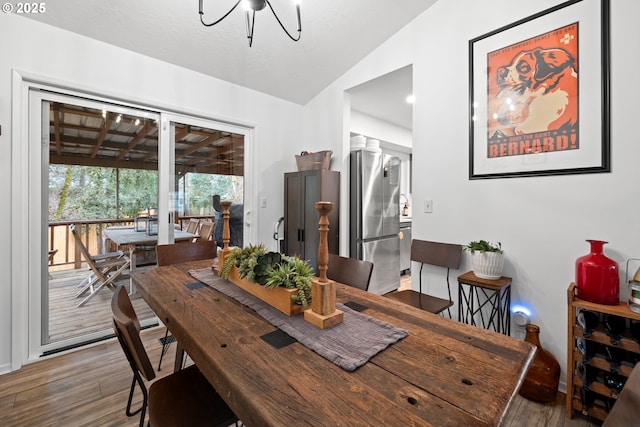 14370 SW Wilson Dr, Beaverton, OR 97008 - dining area with vaulted ceiling, wood finished floors, and a chandelier