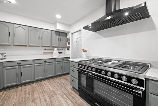 14370 SW Wilson Dr, Beaverton, OR 97008 - kitchen with gas range, gray cabinetry, wall chimney exhaust hood, and recessed lighting