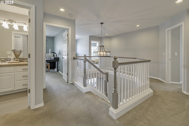 15178 NW Channa Dr, Portland, OR 97229 - hall with light colored carpet, a chandelier, recessed lighting, baseboards, and an upstairs landing
