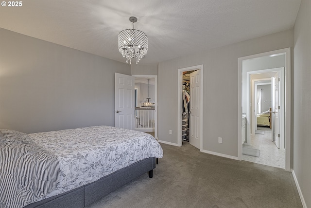 15178 NW Channa Dr, Portland, OR 97229 - bedroom featuring a chandelier, a spacious closet, carpet floors, baseboards, and a closet