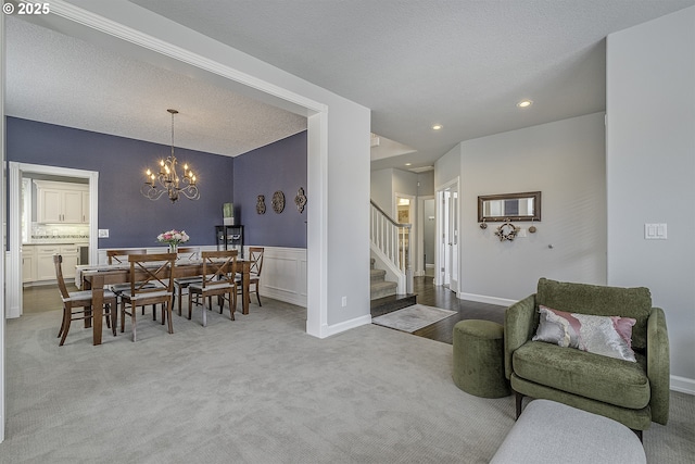 15178 NW Channa Dr, Portland, OR 97229 - living area featuring stairway, a chandelier, carpet flooring, wainscoting, and recessed lighting