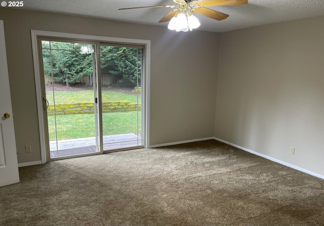 carpeted spare room featuring a textured ceiling, ceiling fan, and baseboards