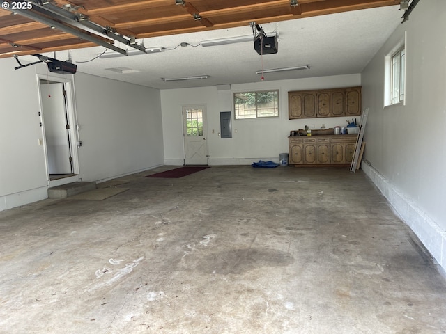 garage with electric panel and a garage door opener