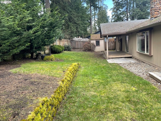 view of yard with fence and a wooden deck