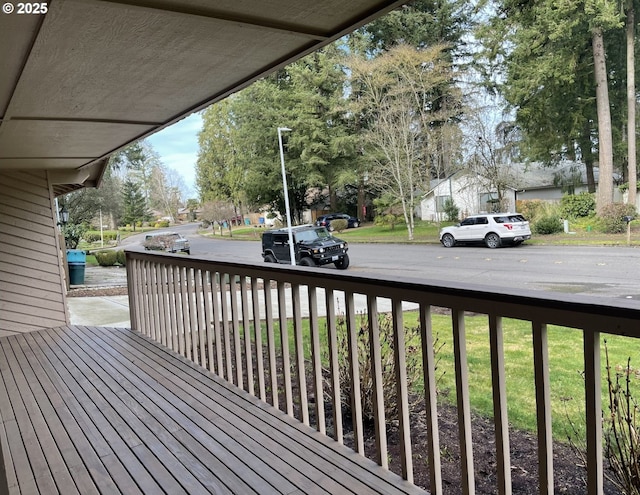 wooden deck featuring a yard