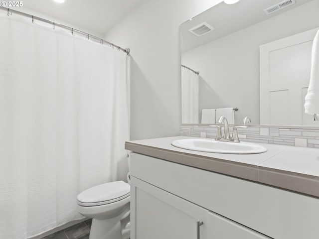 2421 S Trail View Ct, Ridgefield, WA 98642 - full bathroom with vanity, decorative backsplash, toilet, and visible vents