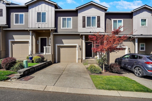 townhome / multi-family property featuring a garage, board and batten siding, and driveway