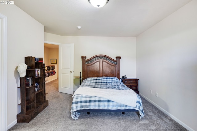 bedroom with baseboards and carpet