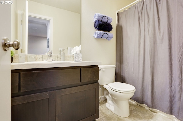 full bathroom with vanity, toilet, and curtained shower