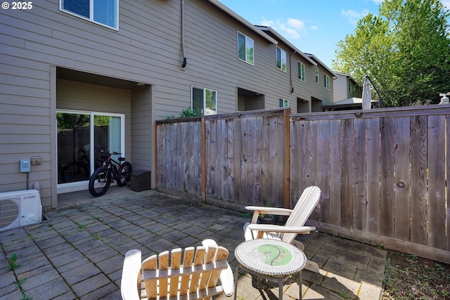 view of patio with fence and ac unit