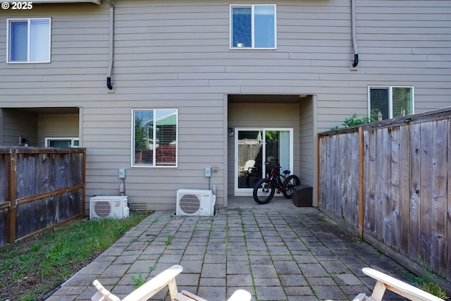 back of property featuring a fenced backyard, a patio area, and ac unit