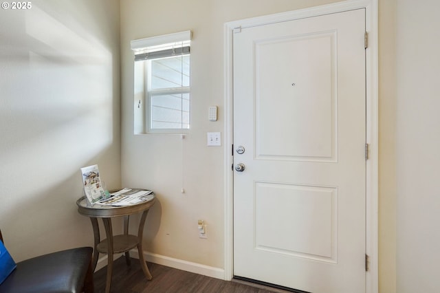 doorway to outside with dark wood-style flooring and baseboards