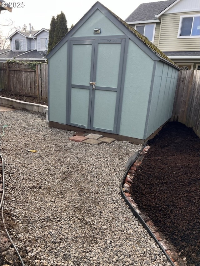 view of shed with a fenced backyard