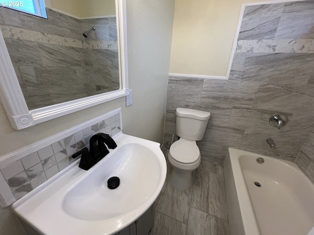 bathroom featuring walk in shower, a sink, toilet, tile walls, and a tub