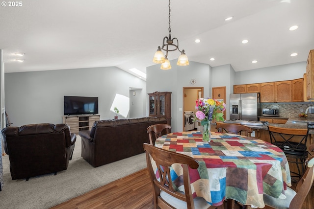 33447 SW Sequoia St, Scappoose, OR 97056 - dining area featuring wood finished floors, washing machine and clothes dryer, lofted ceiling, and recessed lighting