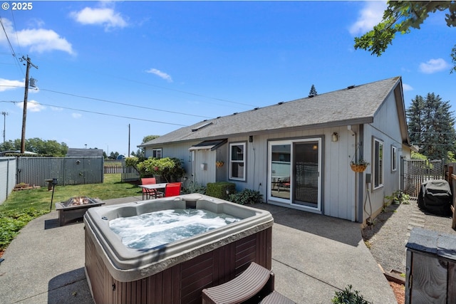 33447 SW Sequoia St, Scappoose, OR 97056 - rear view of house with a hot tub, an outdoor fire pit, a patio, and a fenced backyard