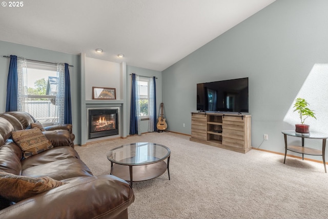 33447 SW Sequoia St, Scappoose, OR 97056 - living area with lofted ceiling, carpet, a glass covered fireplace, and baseboards