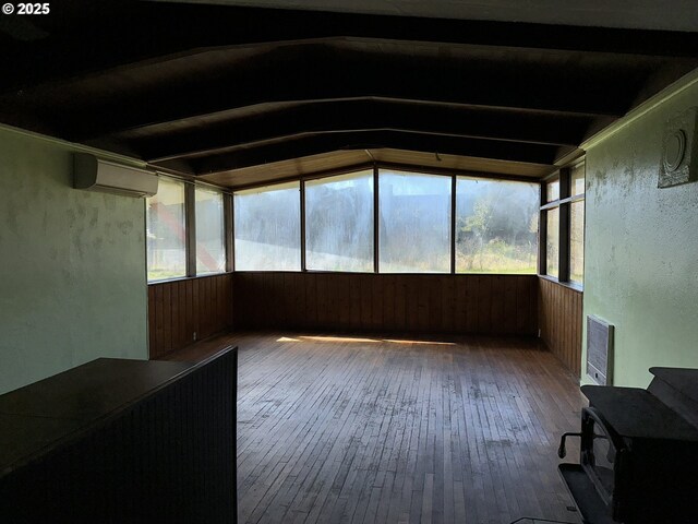 unfurnished sunroom with beamed ceiling and a wall unit AC