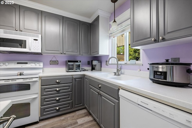 1650 NW Lakeway Ln, Beaverton, OR 97006 - kitchen with white appliances, gray cabinetry, a sink, and light wood finished floors