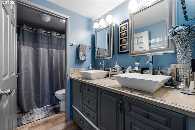 1650 NW Lakeway Ln, Beaverton, OR 97006 - full bath featuring wood finished floors, toilet, double vanity, and a shower with shower curtain