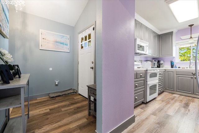 1650 NW Lakeway Ln, Beaverton, OR 97006 - kitchen featuring gray cabinetry, white appliances, light wood finished floors, light countertops, and vaulted ceiling