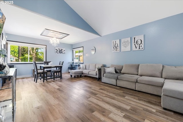 1650 NW Lakeway Ln, Beaverton, OR 97006 - living room featuring a chandelier, wood finished floors, and vaulted ceiling