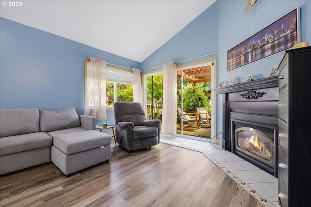 1650 NW Lakeway Ln, Beaverton, OR 97006 - living area with a glass covered fireplace, wood finished floors, and high vaulted ceiling