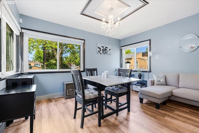 1650 NW Lakeway Ln, Beaverton, OR 97006 - dining area featuring a chandelier, light wood-style flooring, and baseboards