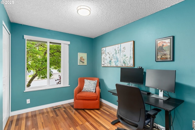 17954 NW Andria Ave, Portland, OR 97229 - office area with a textured ceiling, wood finished floors, and baseboards