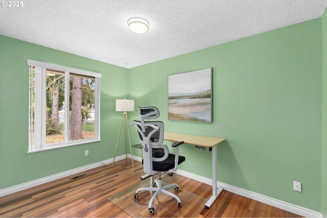 17954 NW Andria Ave, Portland, OR 97229 - office featuring a textured ceiling, baseboards, and wood finished floors
