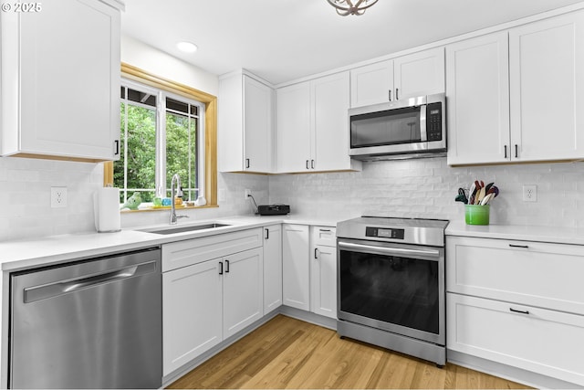 767 SW 8th St, Gresham, OR 97080 - kitchen featuring stainless steel appliances, a sink, light countertops, white cabinets, and recessed lighting