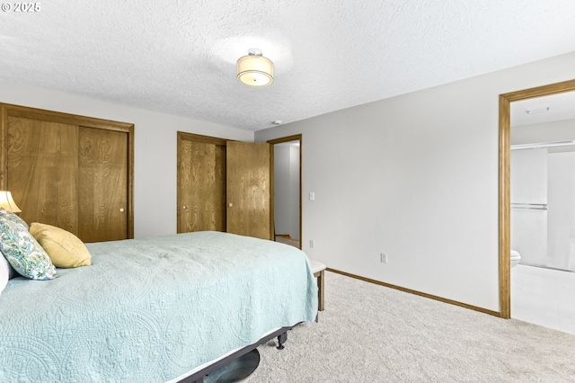 767 SW 8th St, Gresham, OR 97080 - bedroom with carpet floors, multiple closets, connected bathroom, baseboards, and a textured ceiling