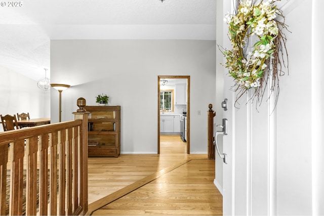 767 SW 8th St, Gresham, OR 97080 - hallway with light wood-type flooring, an upstairs landing, and baseboards