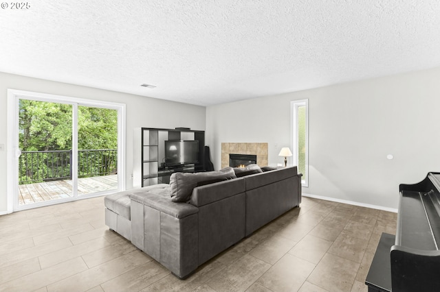 767 SW 8th St, Gresham, OR 97080 - living area with plenty of natural light, a fireplace, a textured ceiling, and baseboards