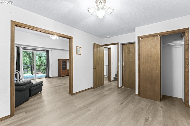 767 SW 8th St, Gresham, OR 97080 - bedroom with light wood-type flooring, a textured ceiling, multiple closets, and access to outside