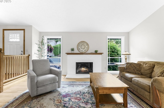 767 SW 8th St, Gresham, OR 97080 - living room featuring healthy amount of natural light, wood finished floors, and a warm lit fireplace