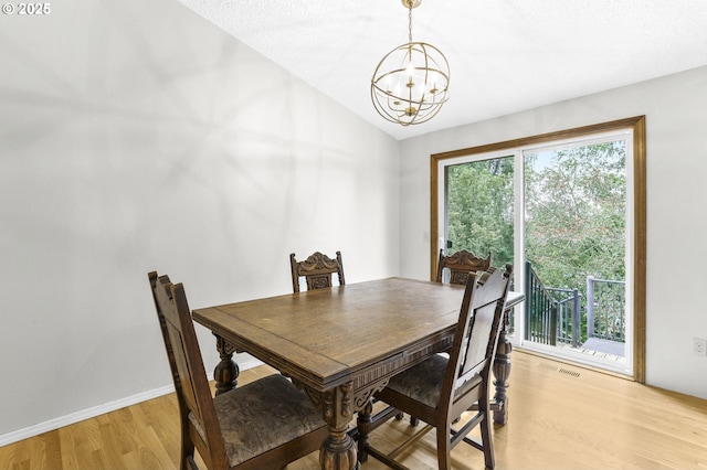 767 SW 8th St, Gresham, OR 97080 - dining space featuring a chandelier, light wood finished floors, vaulted ceiling, and baseboards