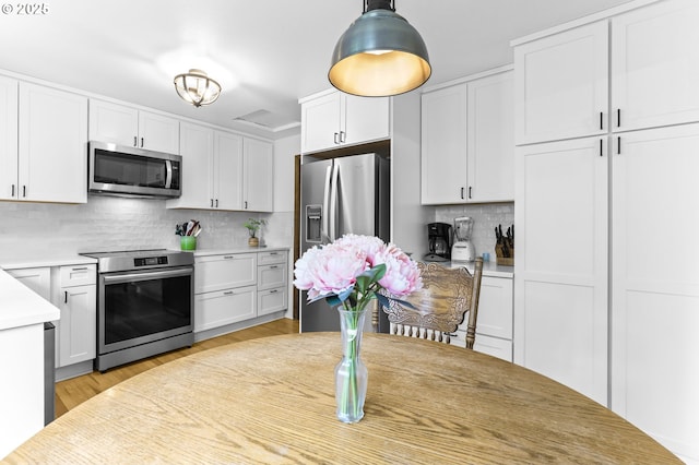 767 SW 8th St, Gresham, OR 97080 - kitchen with stainless steel appliances, decorative backsplash, light countertops, and white cabinetry