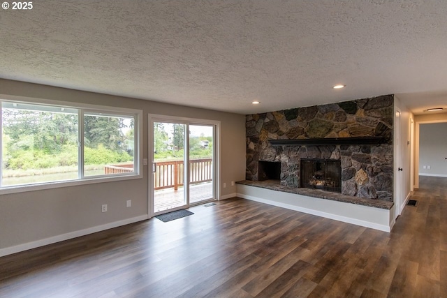 12190 SW Merestone Ct, Tigard, OR 97223 - unfurnished living room featuring a textured ceiling, baseboards, dark wood finished floors, a fireplace, and recessed lighting