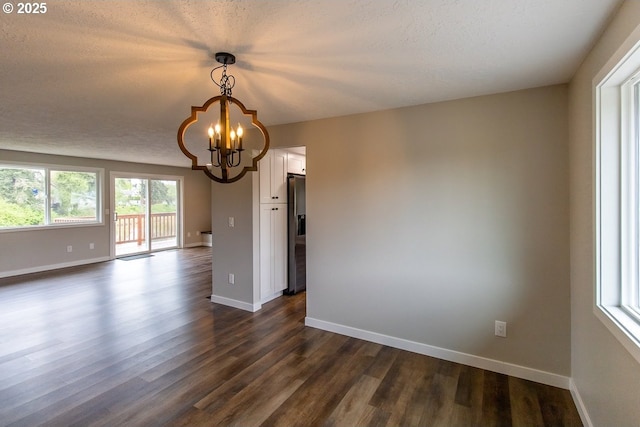 12190 SW Merestone Ct, Tigard, OR 97223 - unfurnished room featuring a chandelier, dark wood-style flooring, baseboards, and a textured ceiling