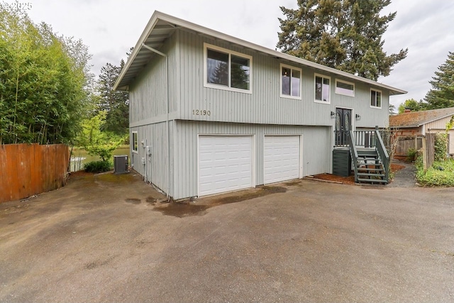 12190 SW Merestone Ct, Tigard, OR 97223 - bi-level home with central AC unit and a detached garage