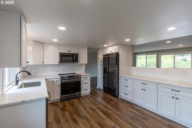12190 SW Merestone Ct, Tigard, OR 97223 - kitchen with appliances with stainless steel finishes, a sink, backsplash, white cabinets, and light stone counters