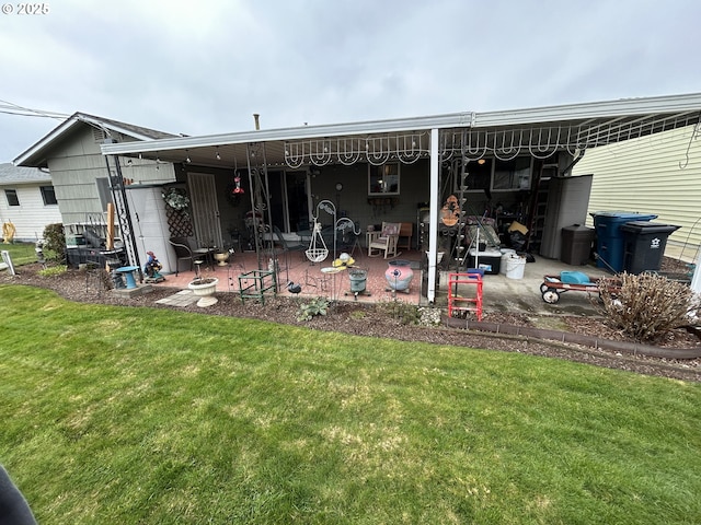 back of property featuring a lawn and a patio area