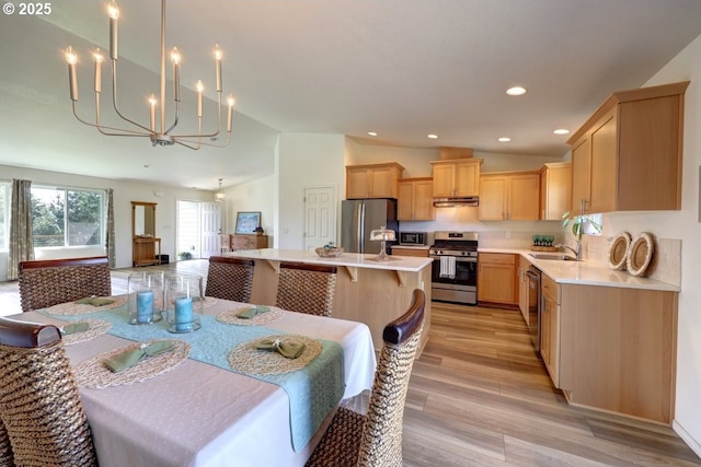 89650 Sea Breeze Dr, Warrenton, OR 97146 - dining room featuring lofted ceiling, a chandelier, light wood finished floors, and recessed lighting
