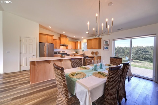 89650 Sea Breeze Dr, Warrenton, OR 97146 - dining space with light wood finished floors, vaulted ceiling, a chandelier, and recessed lighting