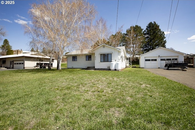 bungalow-style house with an outdoor structure, a front yard, and a detached garage