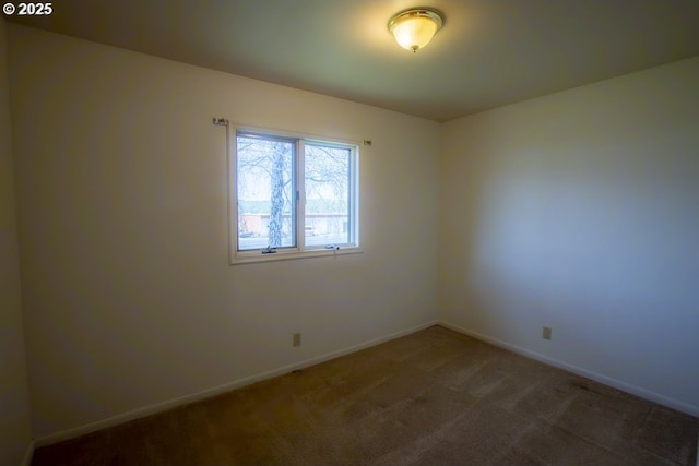 carpeted empty room with baseboards