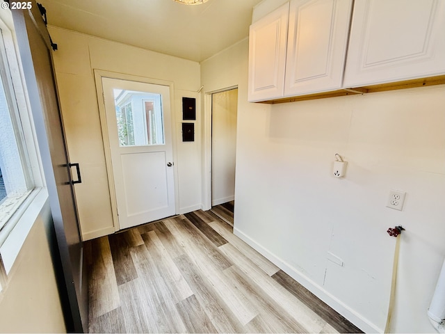 551 NW T St, Winston, OR 97496 - laundry area with cabinet space, light wood-style flooring, and baseboards